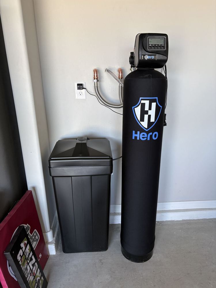 Hero water softener system installed against garage wall