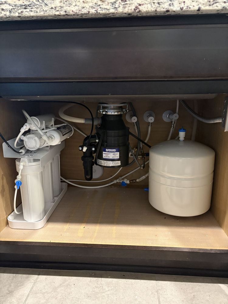Reverse osmosis drinking water system installed under kitchen sink