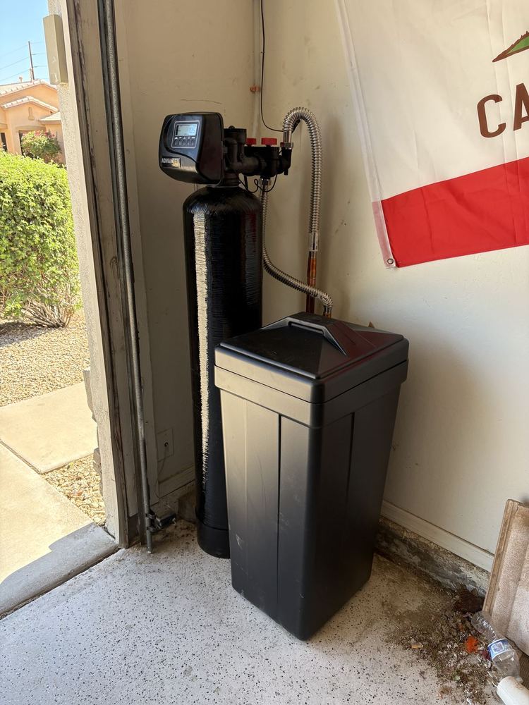 Water softener system installed at a home entryway